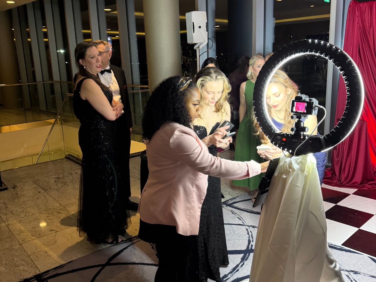 Attendant guiding guests through the Women in Data branded photo activation