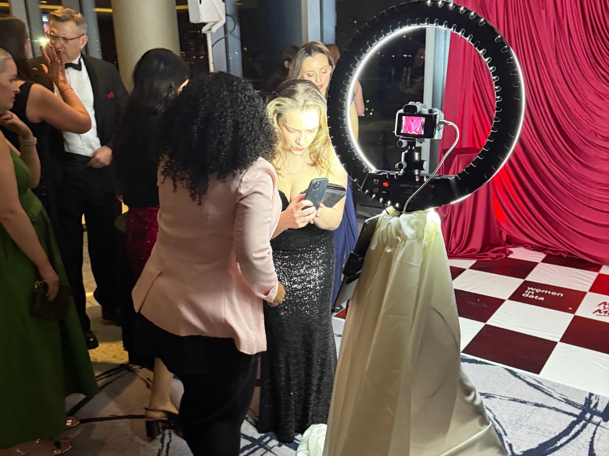 Guests reviewing their photographs at the Women in Data Gala Awards