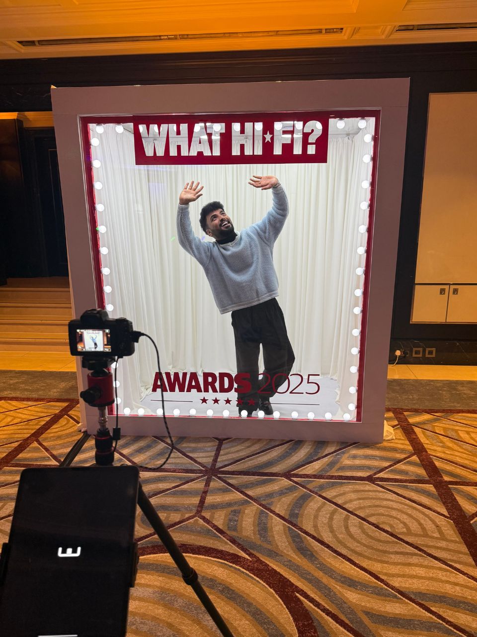 Guest celebrating inside a What Hi-Fi? Awards 2025 branded magazine photo booth