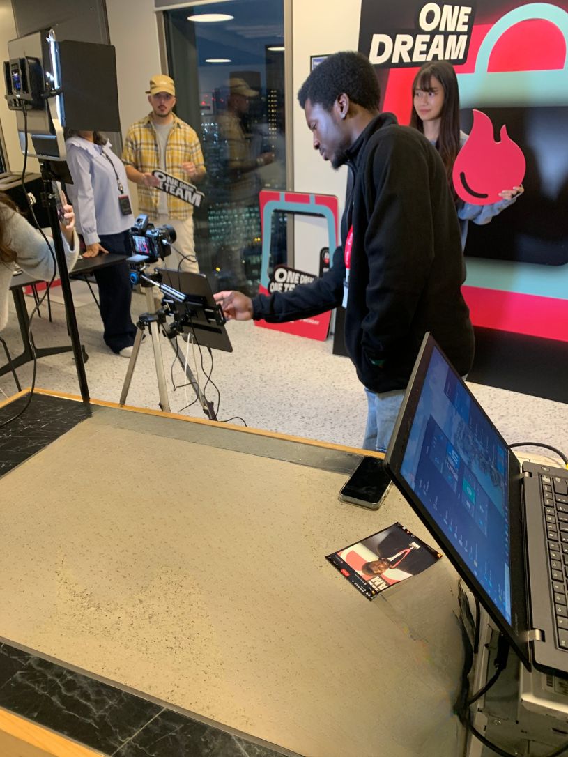 Branded TikTok photo activation set up on the event floor with colleagues nearby