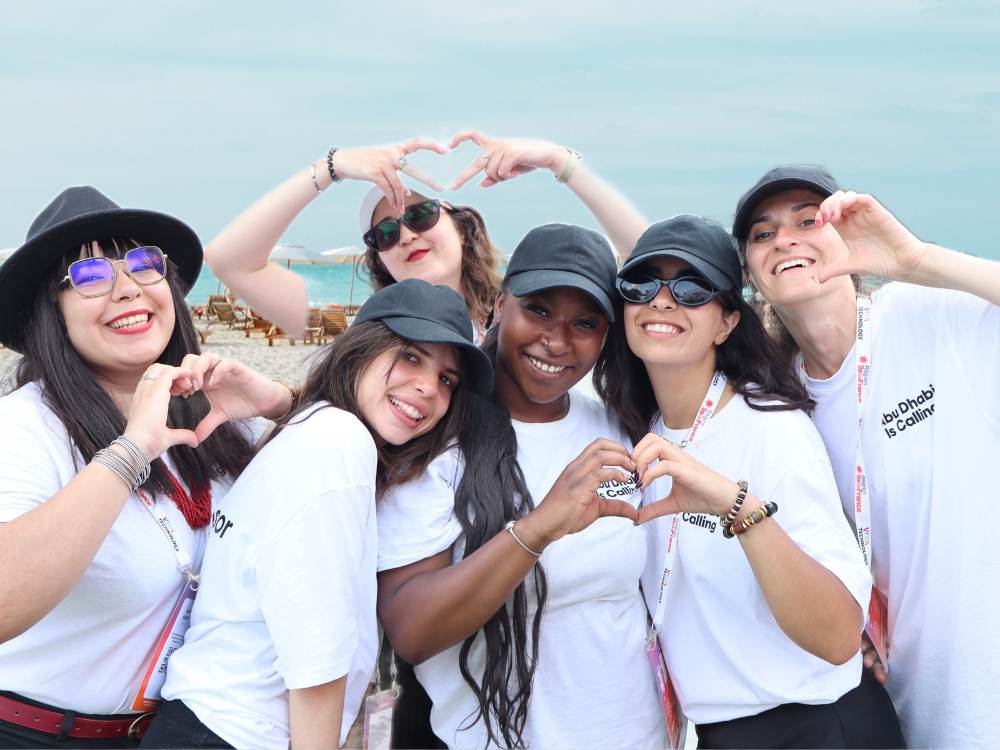 Guests making heart shapes with their hands during the destination activation
