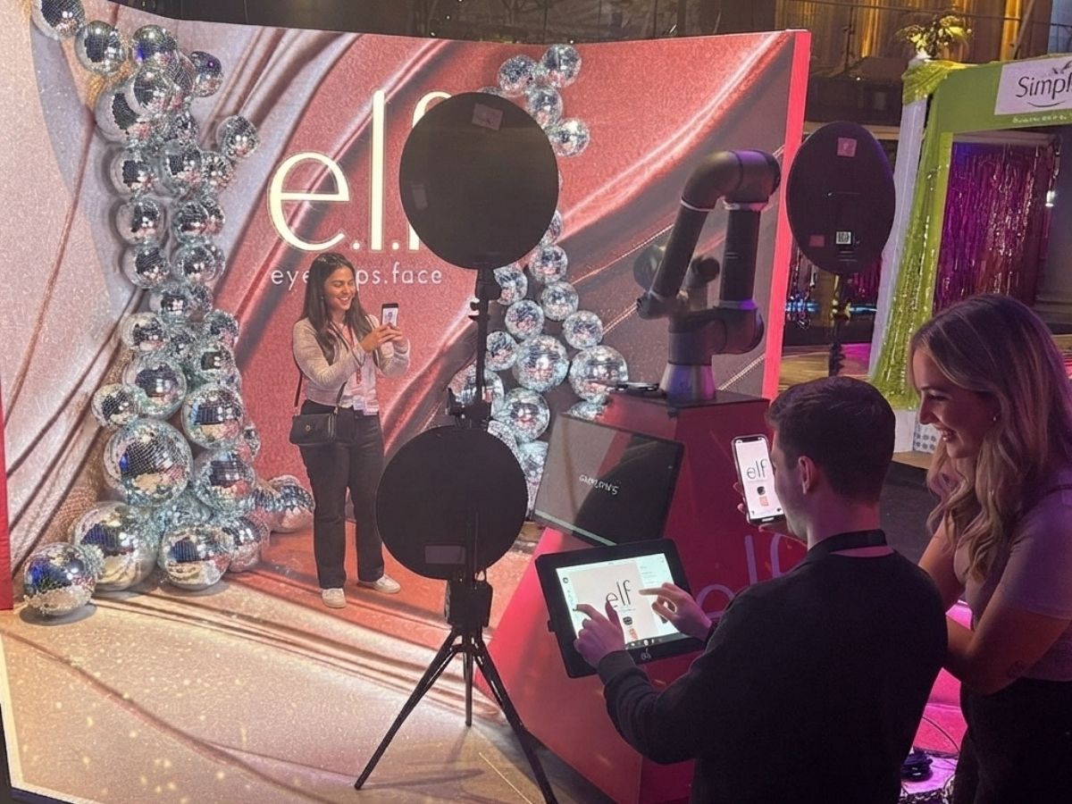 Event guests sharing their portraits to their phones at a branded activation