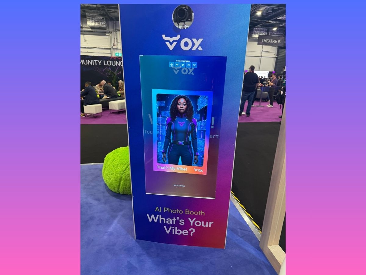 Dual-screen display showing a live VOX Security AI transformation beside the booth