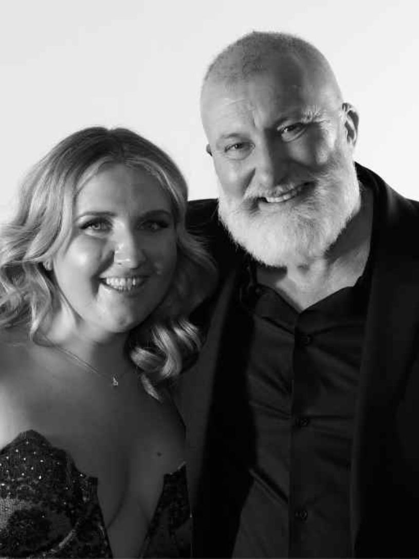 Monochrome portrait of two guests photographed at a black-tie corporate gala in London