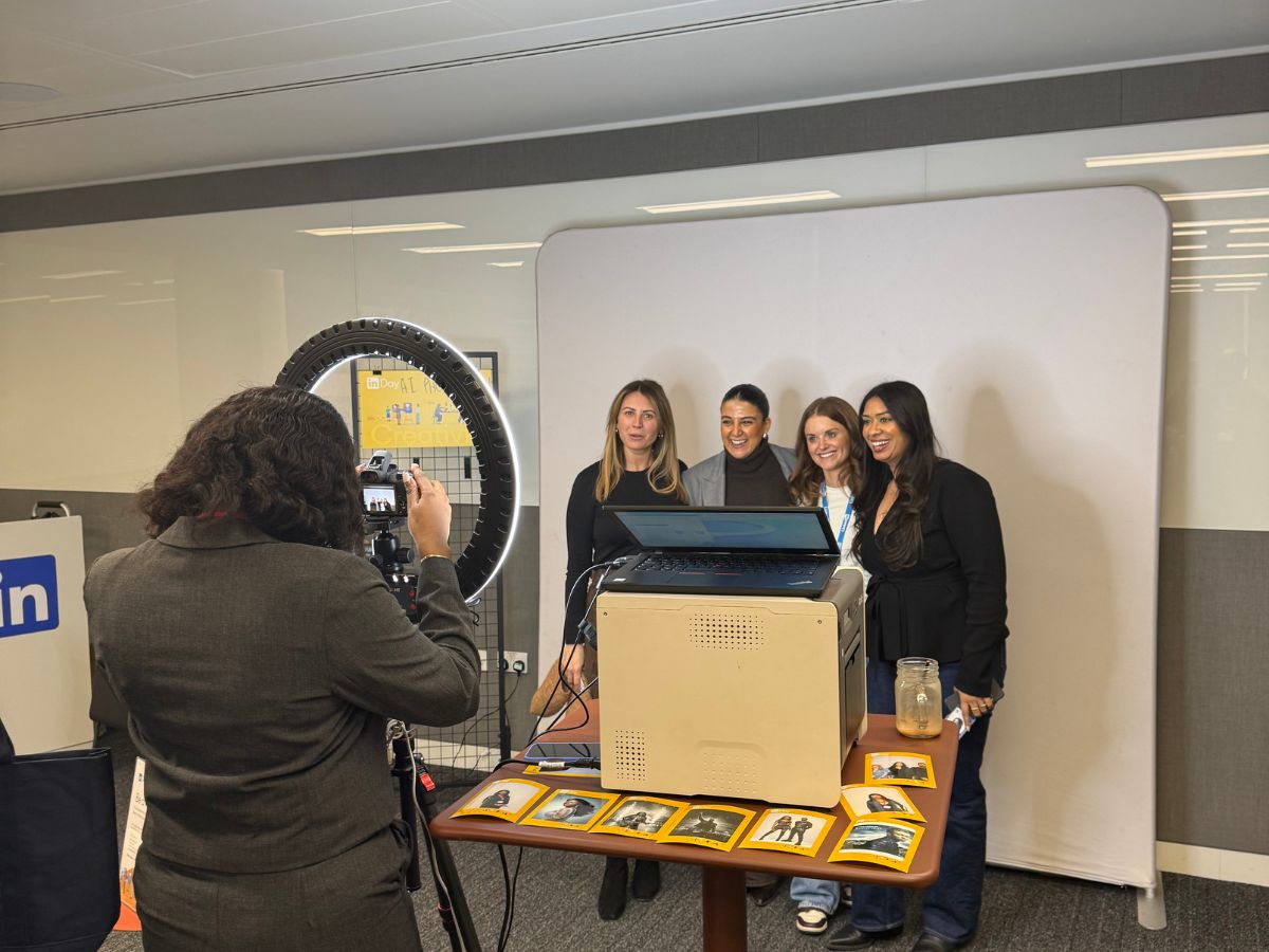 Colleagues gathered at a branded corporate photo experience during a workplace event