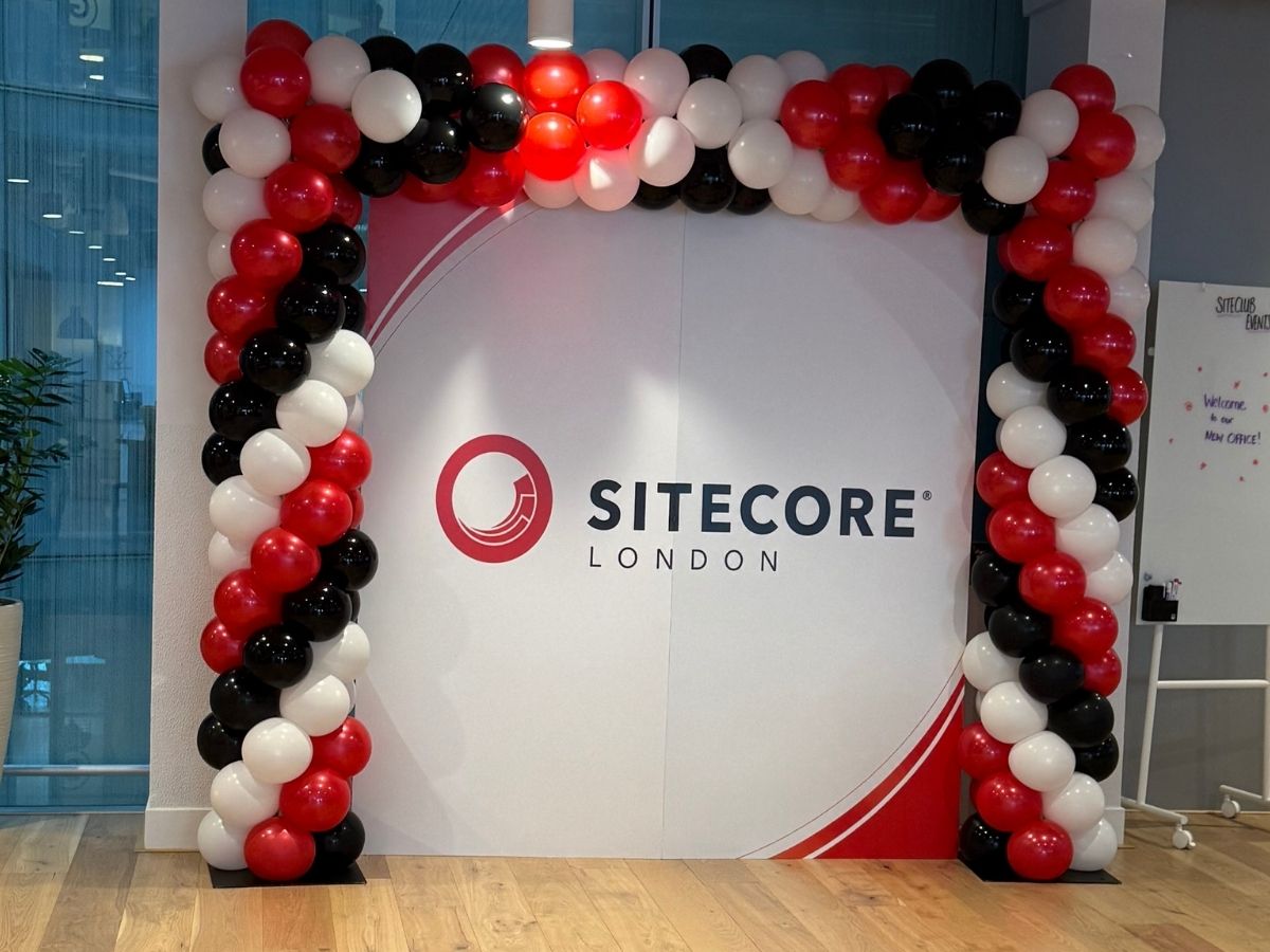 Branded balloon arch and step-and-repeat backdrop built for a corporate photo experience in London