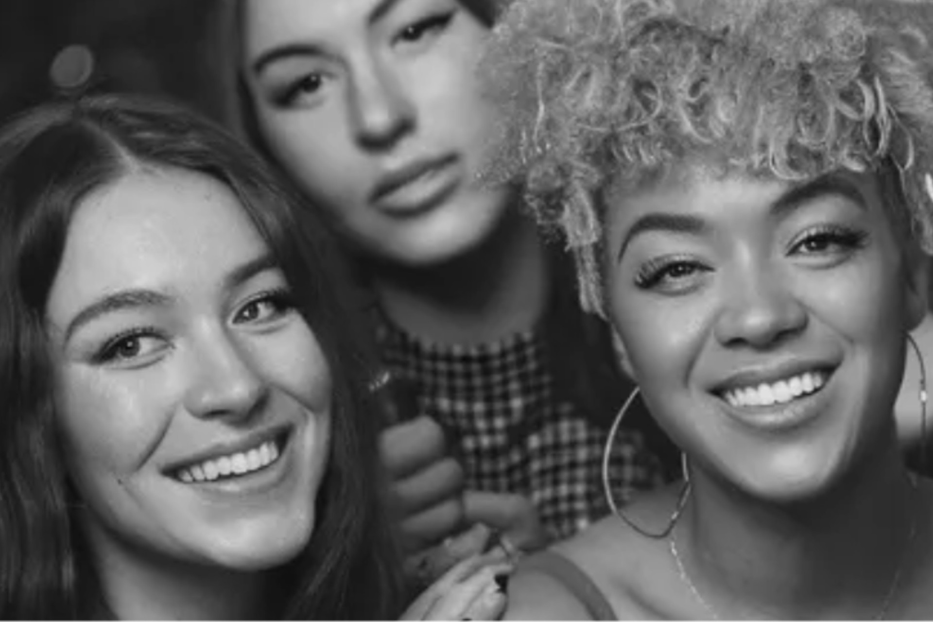 Editorial black-and-white photo booth portraits from a beauty brand activation in London