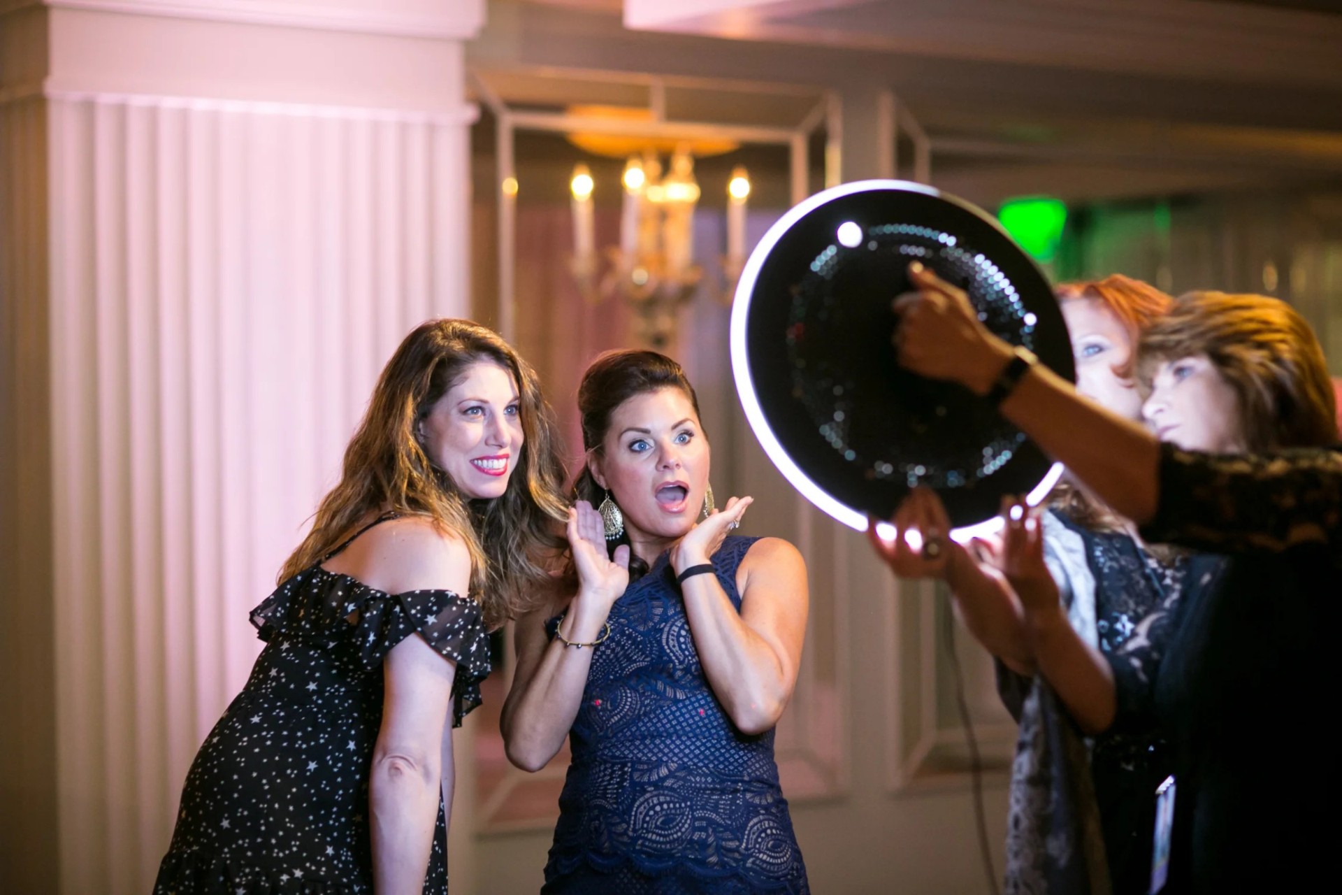 A roaming photographer discreetly captures guests networking and laughing at a premium corporate event in London